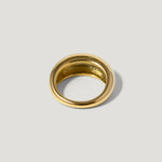Polished gold dome ring with smooth finish on a light background