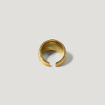 Textured gold open band ring with engraved details on a light background