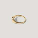 Minimalist gold signet ring on light background, fine jewelry, elegant design