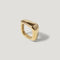 Modern chunky gold ring with smooth, organic shape on light background