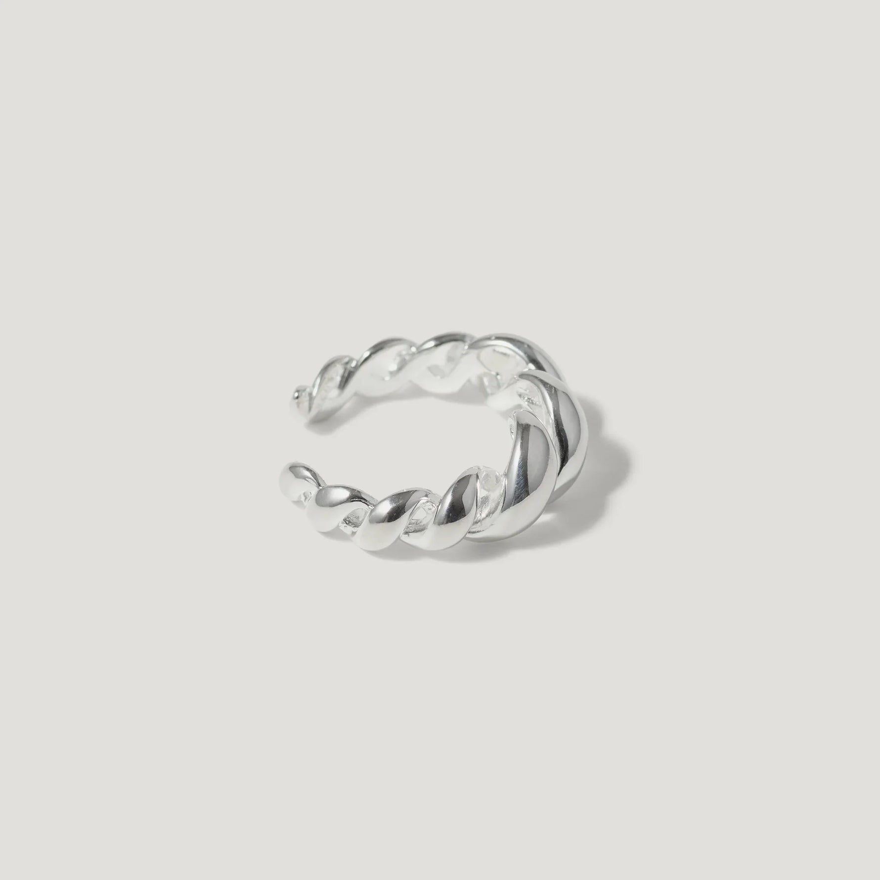 Sterling silver twisted open ring on a white background