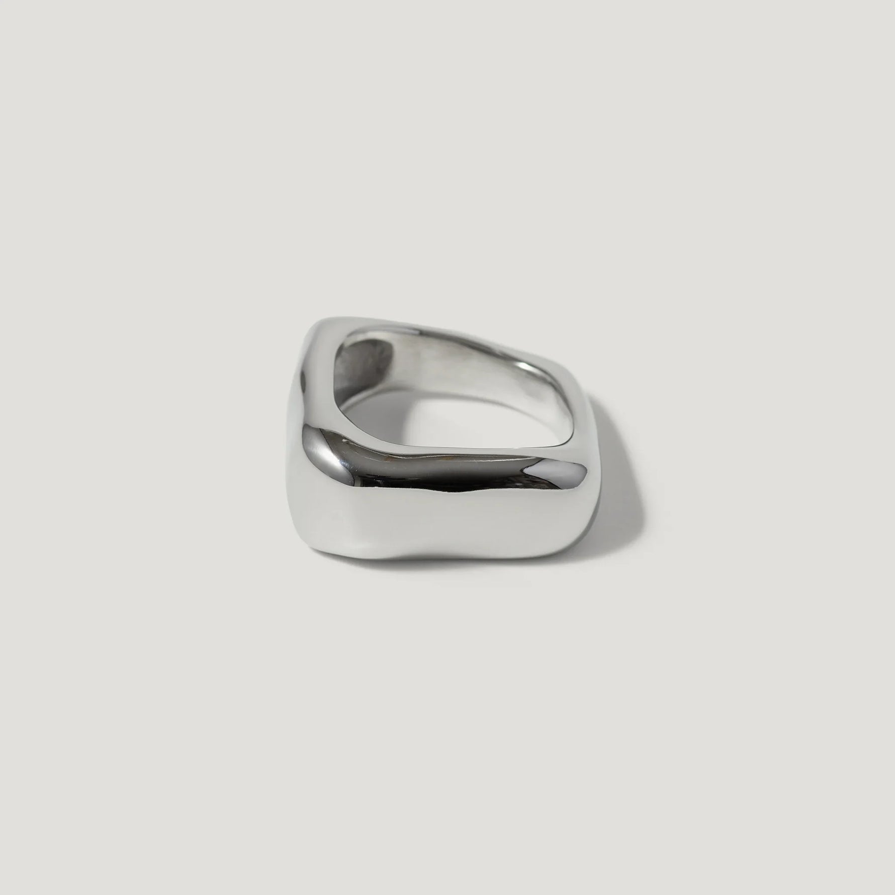 Modern chunky silver square ring with smooth, polished finish on white background