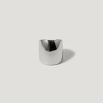 Wide silver statement ring with smooth, polished finish on a light background