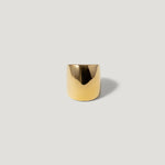 Minimalist wide gold band ring on a plain light background