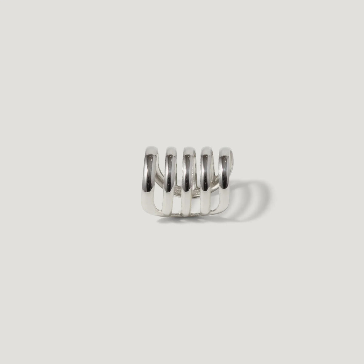 Modern silver ring with multi-band spiral design on a white background