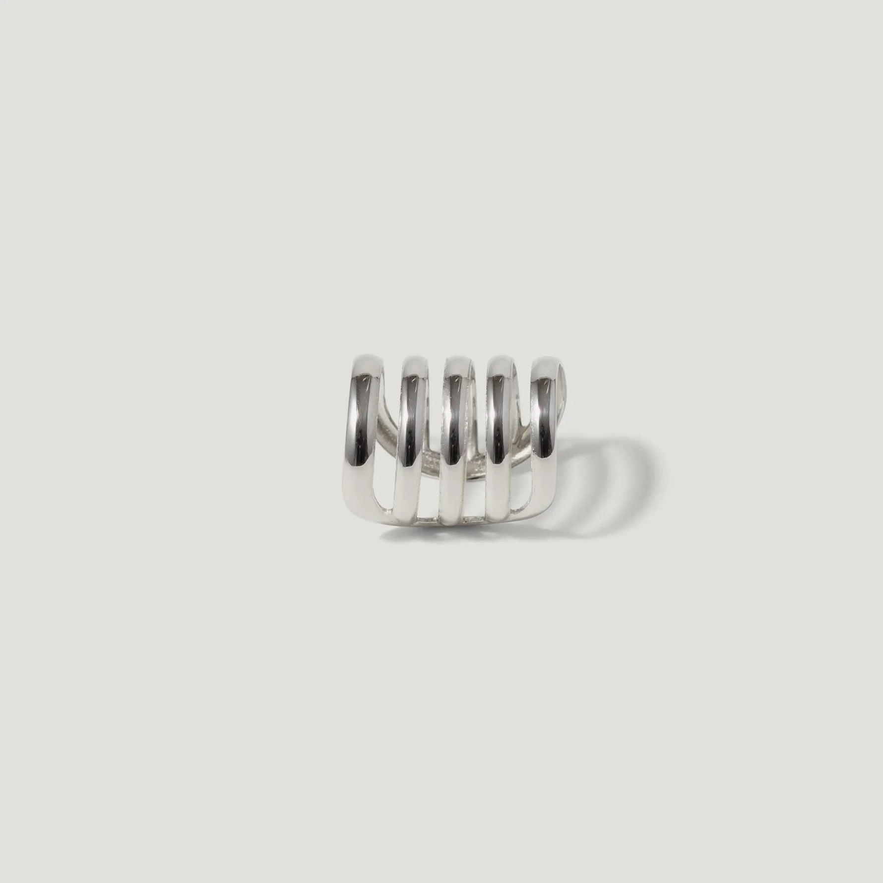Modern silver ring with multi-band spiral design on a white background