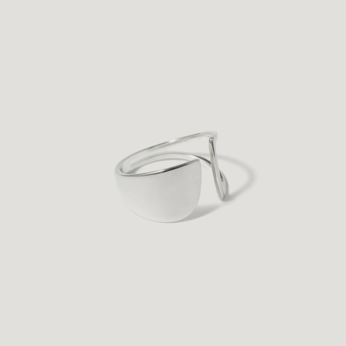 Minimalist silver open ring with geometric design on white background