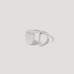 Modern geometric silver ring with open design on white background