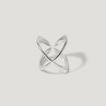 Minimalist open silver ring with intersecting bands on white background