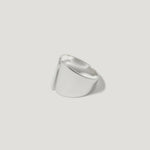 Modern wide sterling silver ring with sculptural, asymmetric design on white background