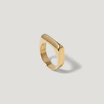 Minimalist gold geometric ring with a smooth rectangular top on a white background