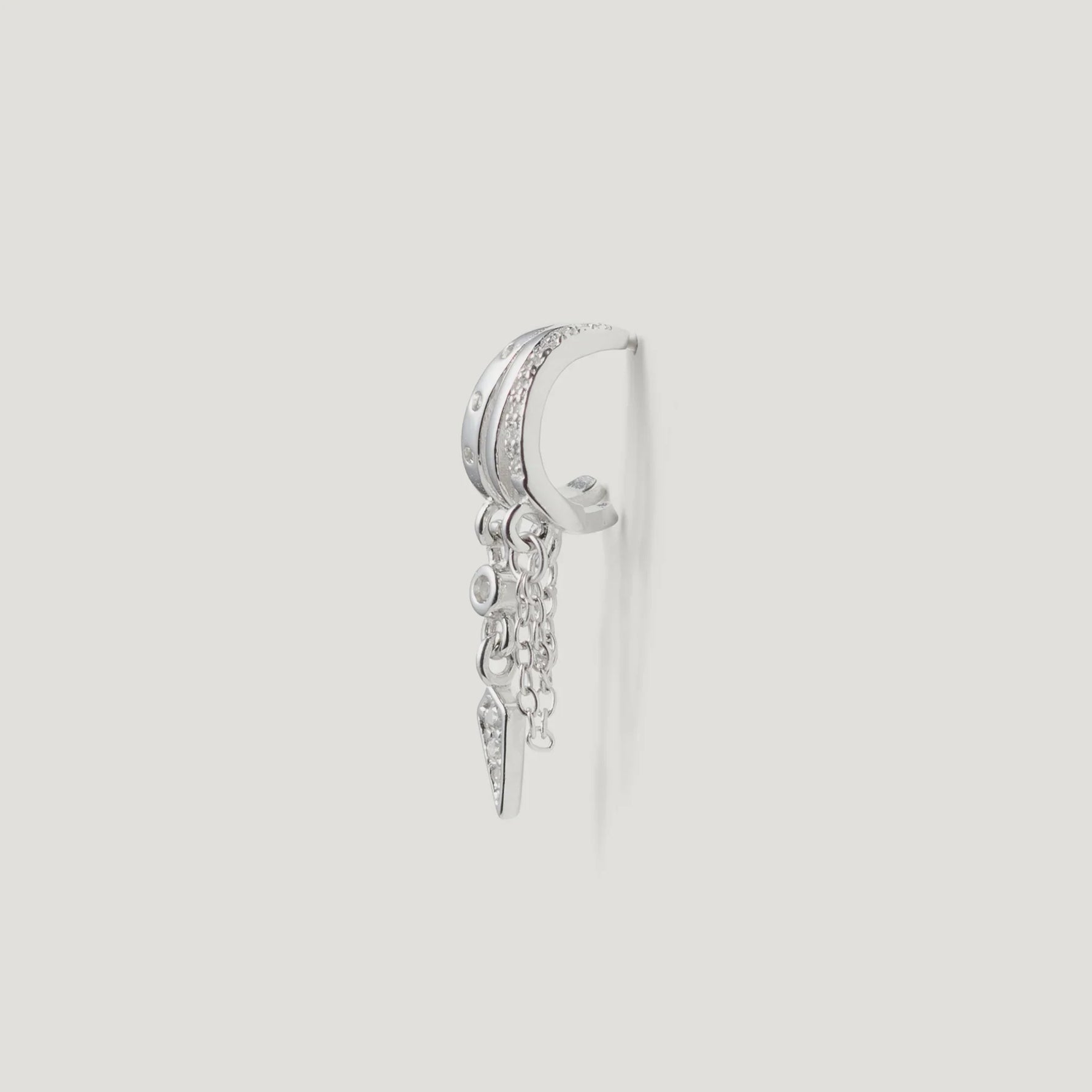 Silver hoop earring with chain dangle and cubic zirconia accents on white background
