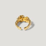 Gold textured open band ring with organic, sculptural design on a light background