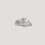 Modern sculptural silver ring with organic wave design on light background