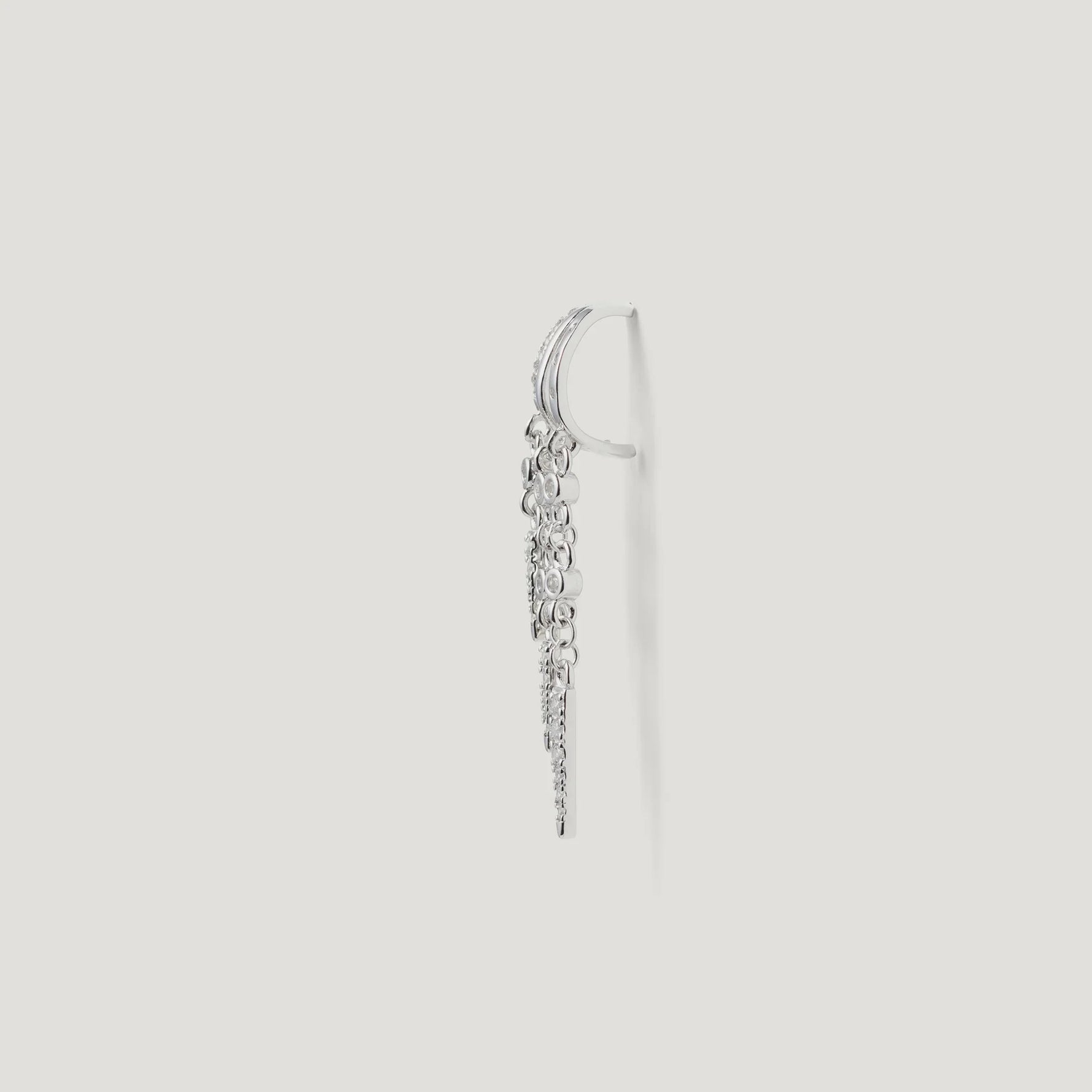 Side view of a silver drop earring with multiple small round and textured charms