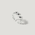 Sterling silver twisted open band ring on a light background