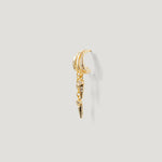Gold ear cuff with dangling geometric charms and clear gemstone accents on light background