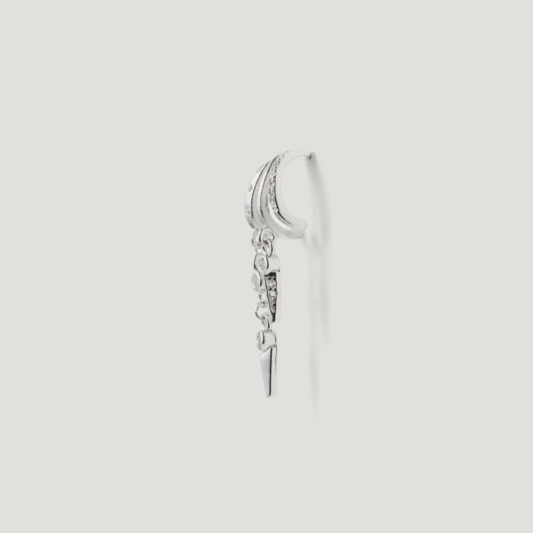 Sterling silver hoop earring with dangle charms and crystal accents on white background