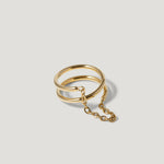 Gold double band chain ring on light background, minimalist jewelry design