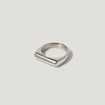 Minimalist silver bar ring with polished finish on a plain light background