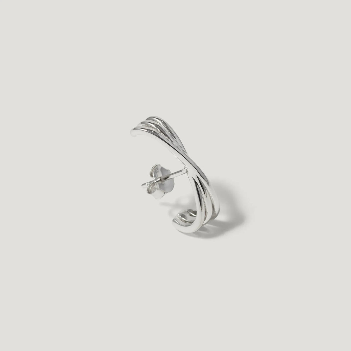 Sterling silver twisted hoop stud earring with polished finish on white background