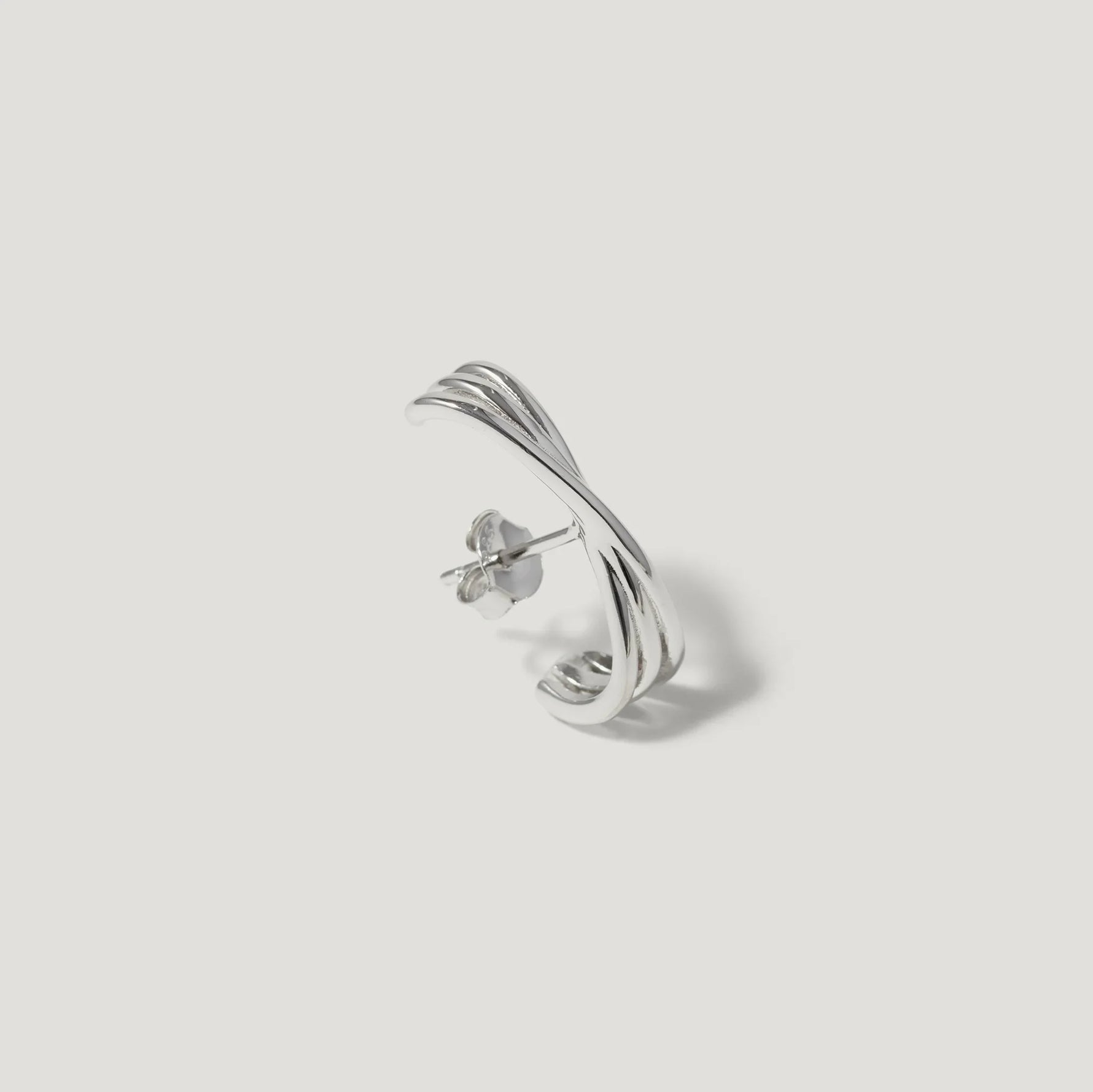 Sterling silver twisted hoop stud earring with polished finish on white background