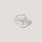 Sterling silver multi-band statement ring with wave design on white background