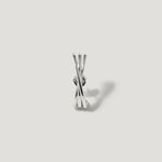 Minimalist silver stud earring with intersecting bars on a light grey background
