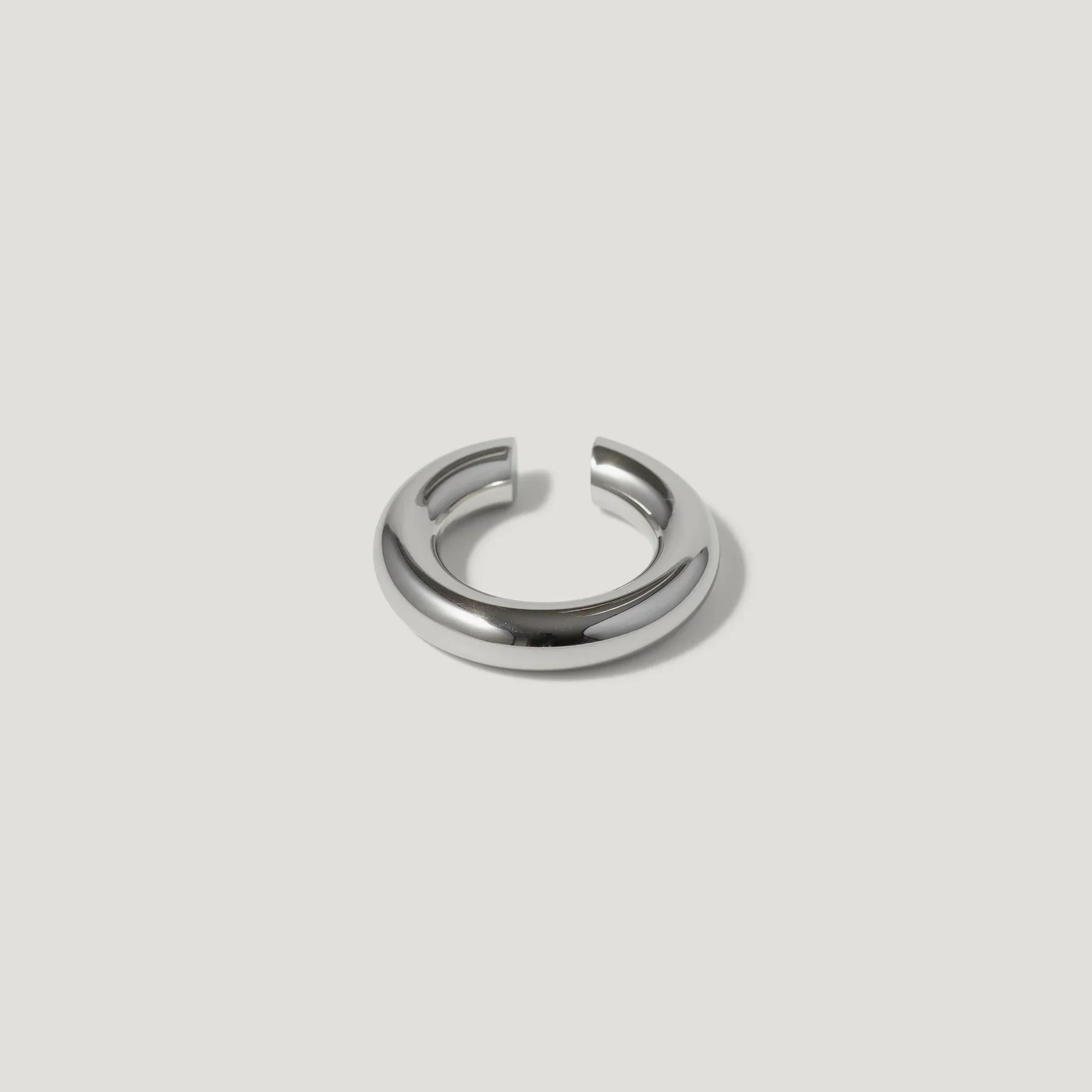 Minimalist silver chunky open ring on a white background