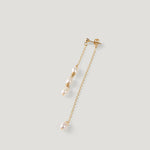 Single gold pearl drop earring laid diagonally, showing clustered pearls and chain.