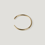 Gold open cuff bangle with rounded wire and ball tip, opening angled to the left.