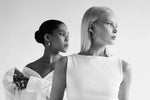 Two women wearing modern silver earrings and rings, posing in minimalistic style