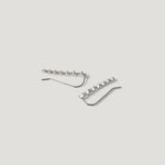 Sterling silver crawler earrings with geometric stone settings on light background