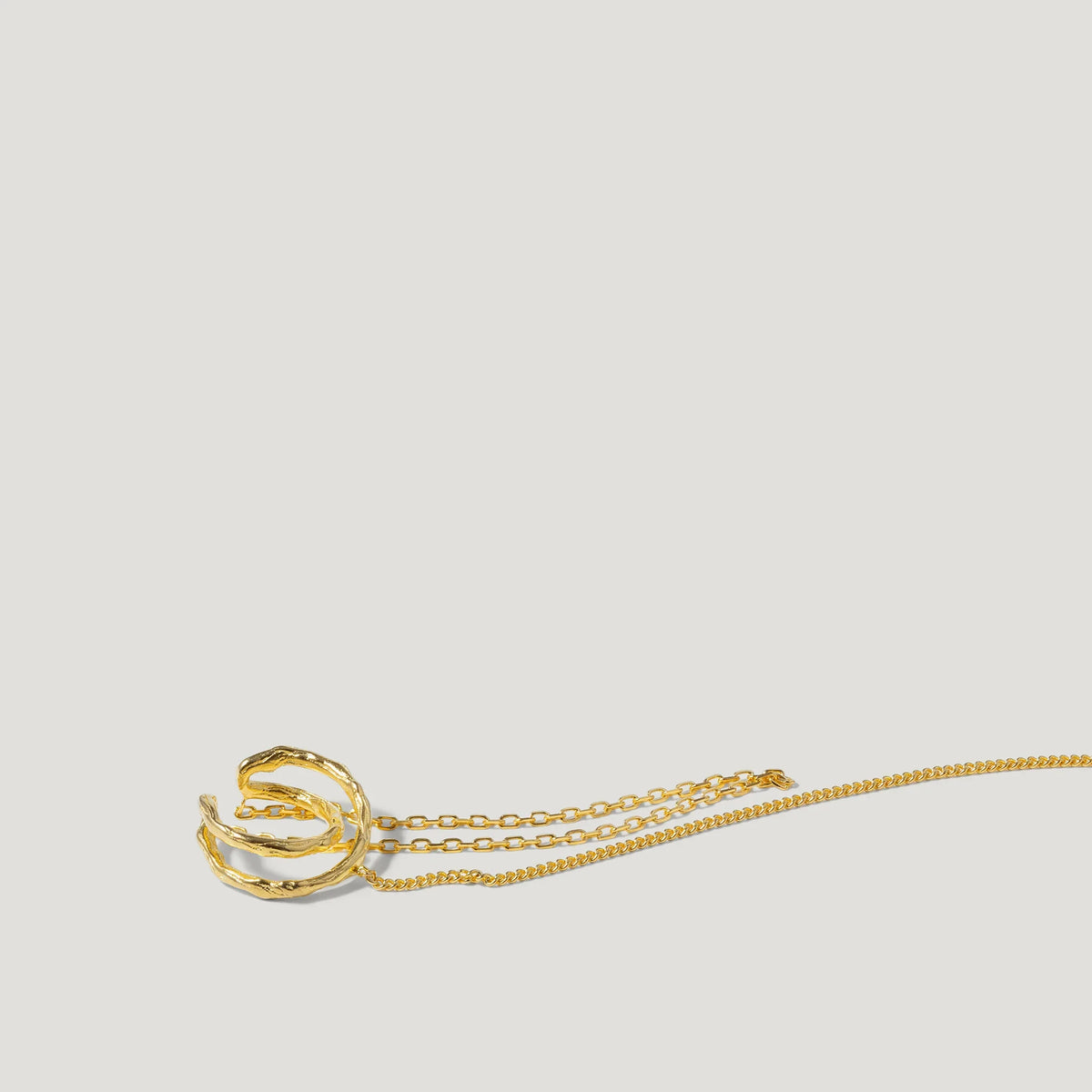 Gold twisted ring pendant necklace on delicate gold chain, minimalist jewelry on white background