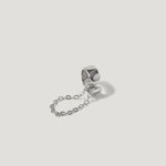 Sterling silver double ring connected by a delicate chain on white background