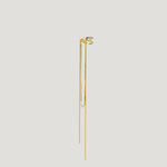 Minimalist gold ear cuff with long dangling chains on white background