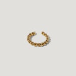 Gold twisted open cuff ring on a white background