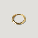 Minimalist gold hoop earring on a light background