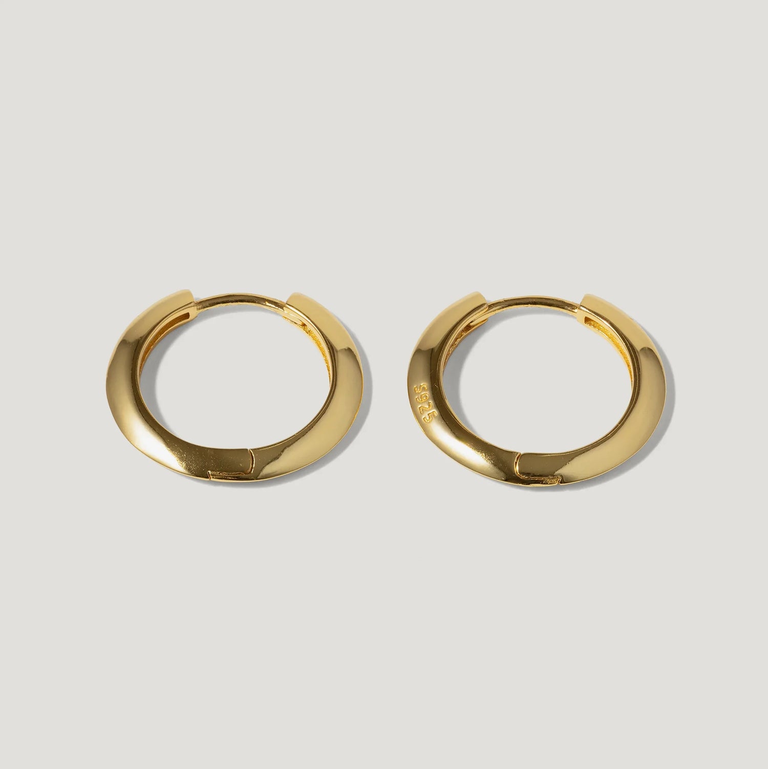 Pair of gold-plated sterling silver hoop earrings on a light background