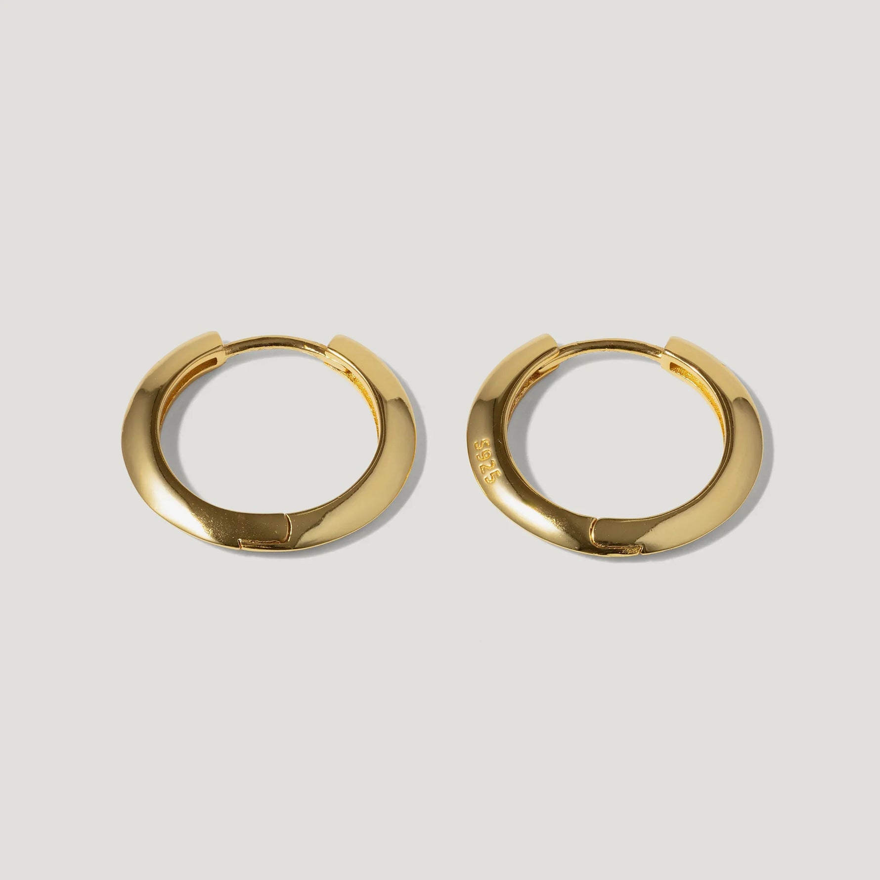 Pair of gold-plated sterling silver hoop earrings on a light background