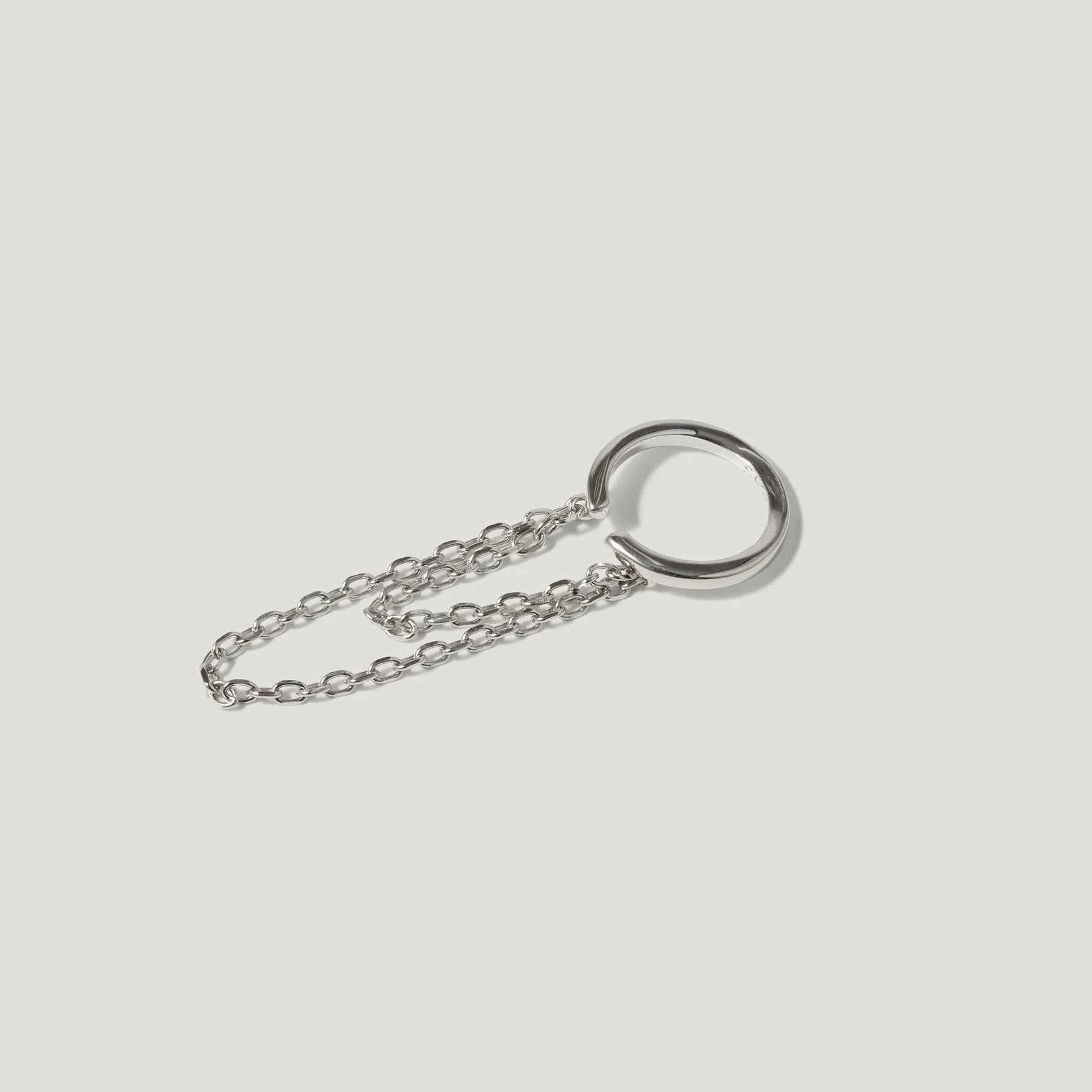 Minimalist silver chain necklace with an open circular pendant on a white background