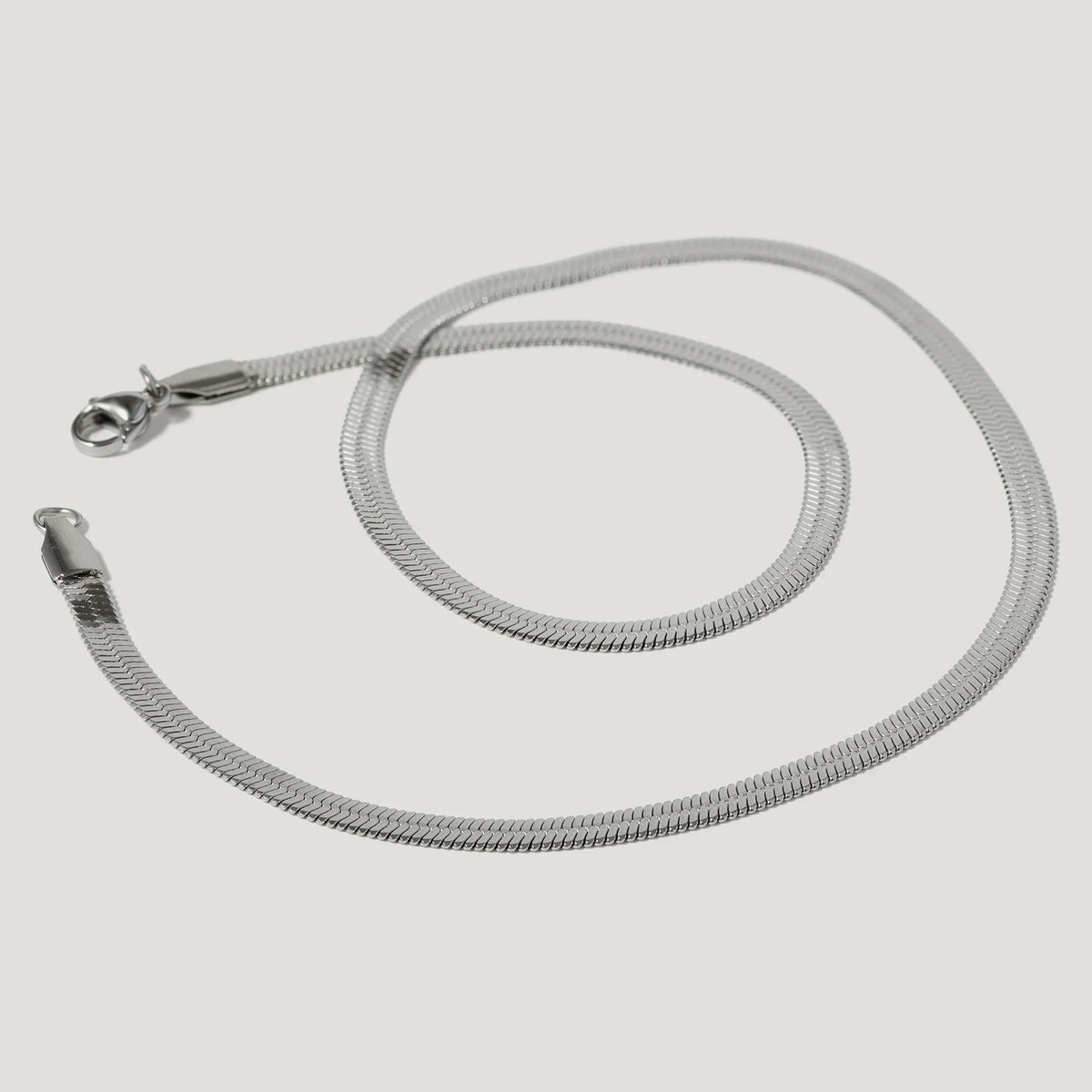 silver herringbone chain necklace with lobster clasp on white background