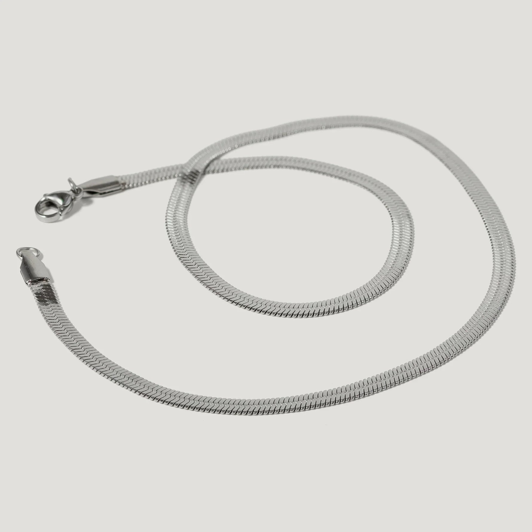 silver herringbone chain necklace with lobster clasp on white background