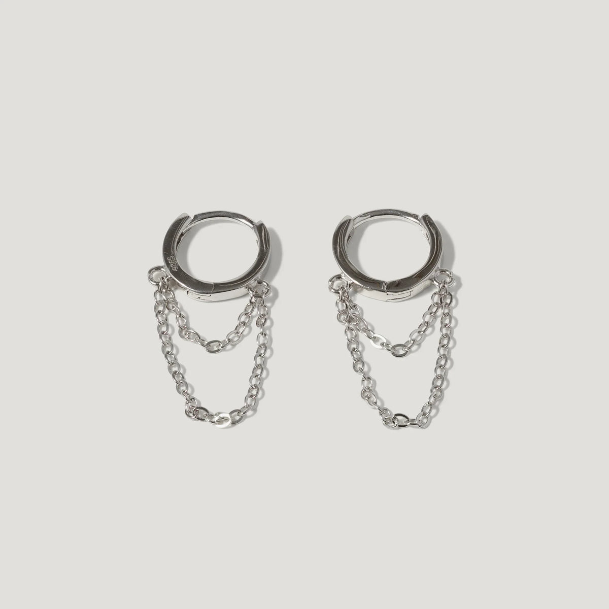 Silver hoop earrings with double chain detail on white background