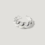 Chunky silver twisted ring with open band on light grey background