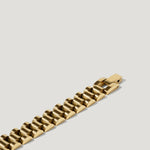 Chunky gold link bracelet with polished finish on a neutral background