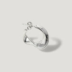 Sterling silver twisted hoop earring with a sculptural, modern design on white background