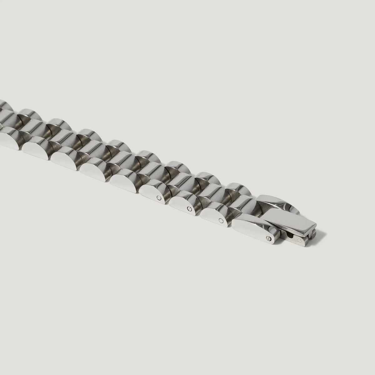 Stainless steel link bracelet with polished finish and secure clasp on white background