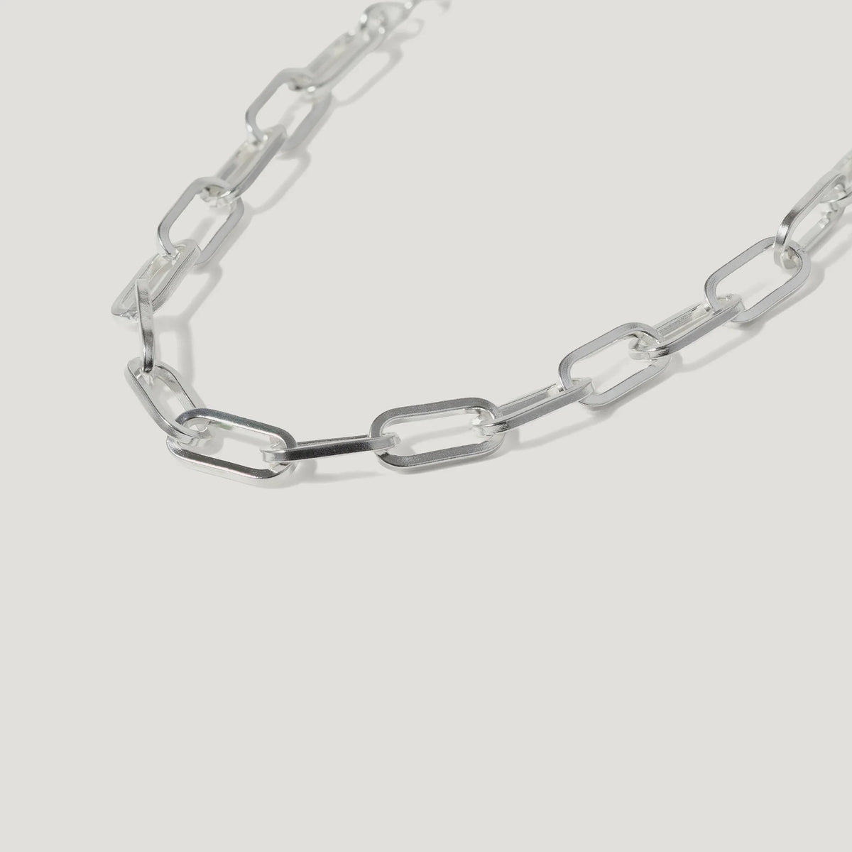 Silver rectangular link chain necklace on white background