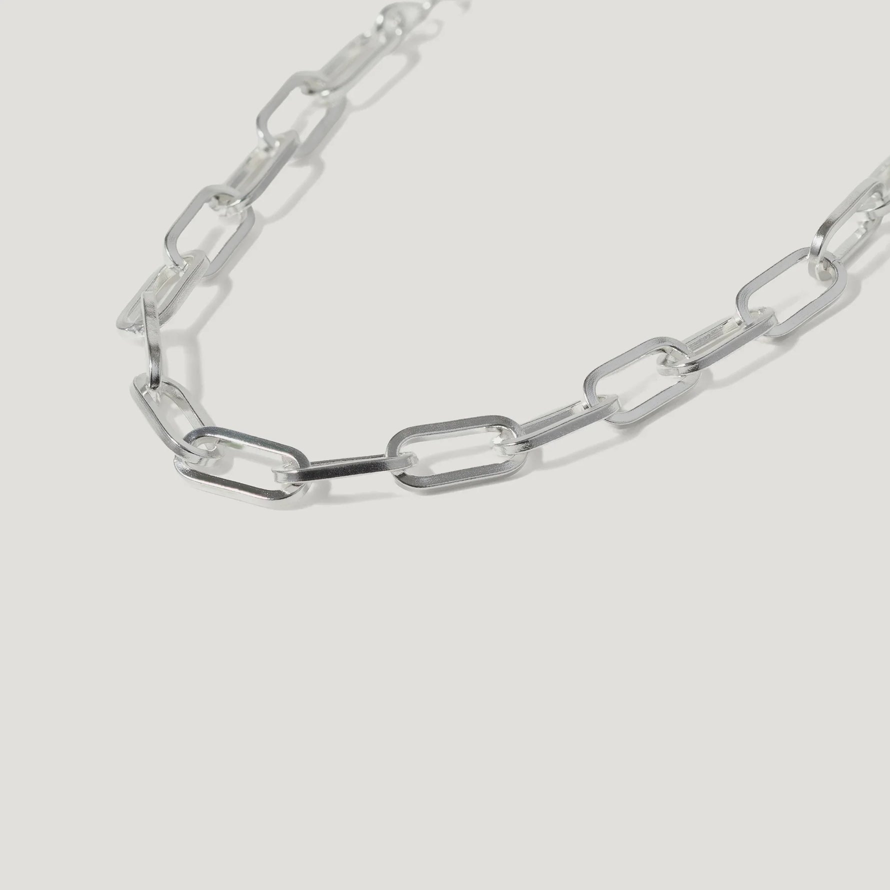 Silver rectangular link chain necklace on white background